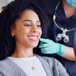 Cosmetic dentistry patient admiring her smile in mirror